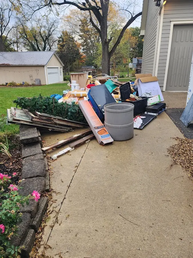 Dumpster being loaded with debris for Estate Cleanout Dumpster Rental in Cherry Hills Village
